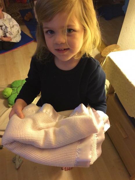 She can fold her nap items!  She is so proud of her work! 